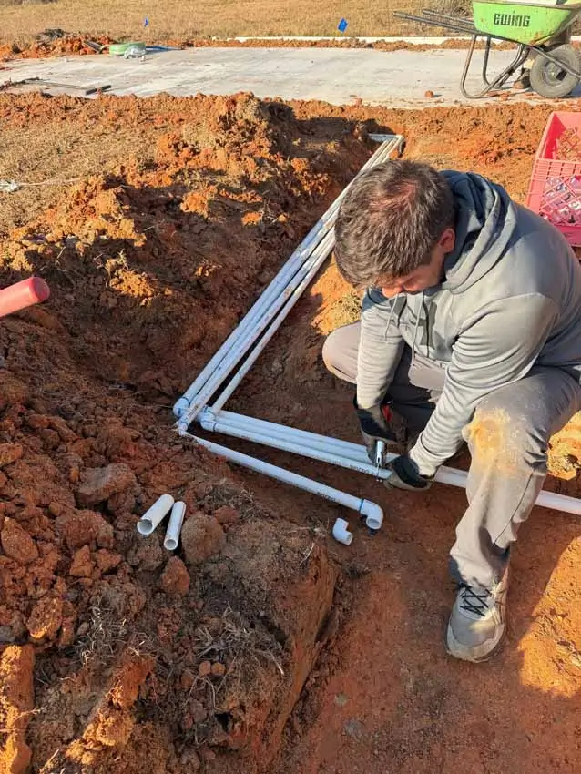 Sprinkler system pipe repair by Clean Cut Landscape Co technician